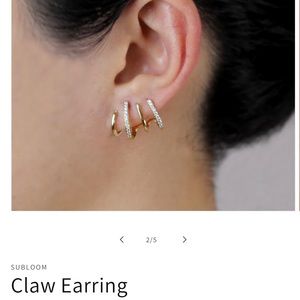 New in box. Super cute one hole earring made to look like 4 hoops.